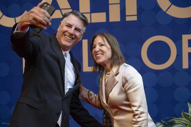 Lt. Gov. Eleni Kounalakis and her husband Markos Kounalakis take a selfie on the red carpet before an induction ceremony of the 19th class of California Hall of Fame inductees at the California Museum in Sacramento on Thursday.